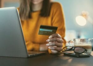 Person paying online with a credit card on a laptop, illustrating secure eCommerce checkout in Botswana