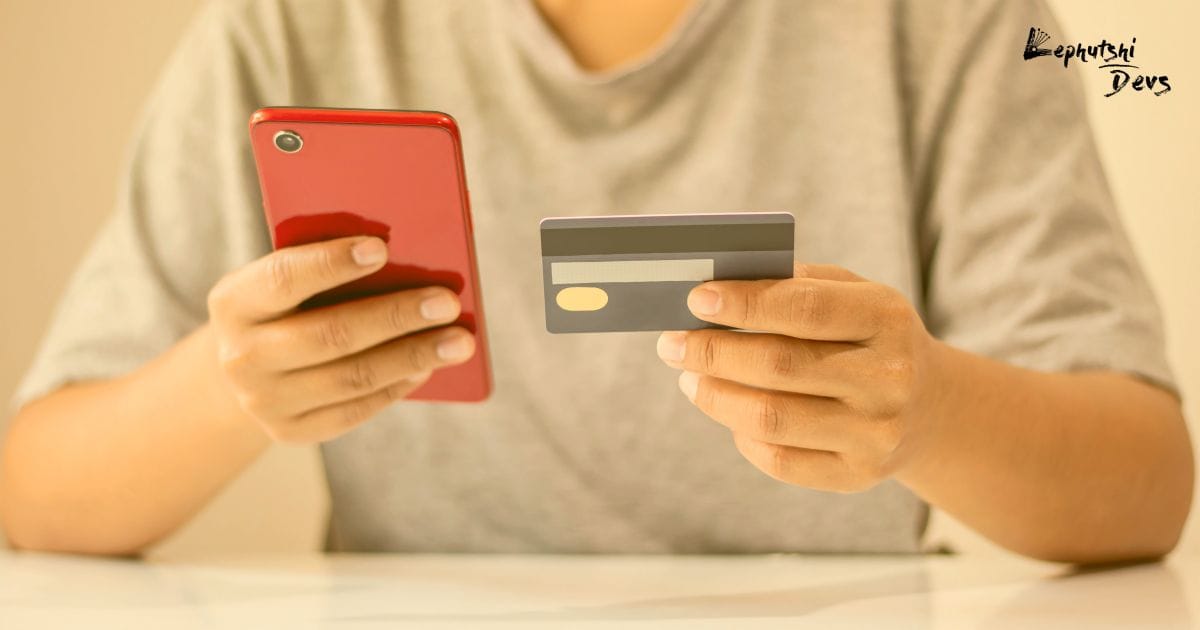 payment gateway botswana - Botswana shopper using a smartphone and debit card to pay online via local payment gateways in Botswana.