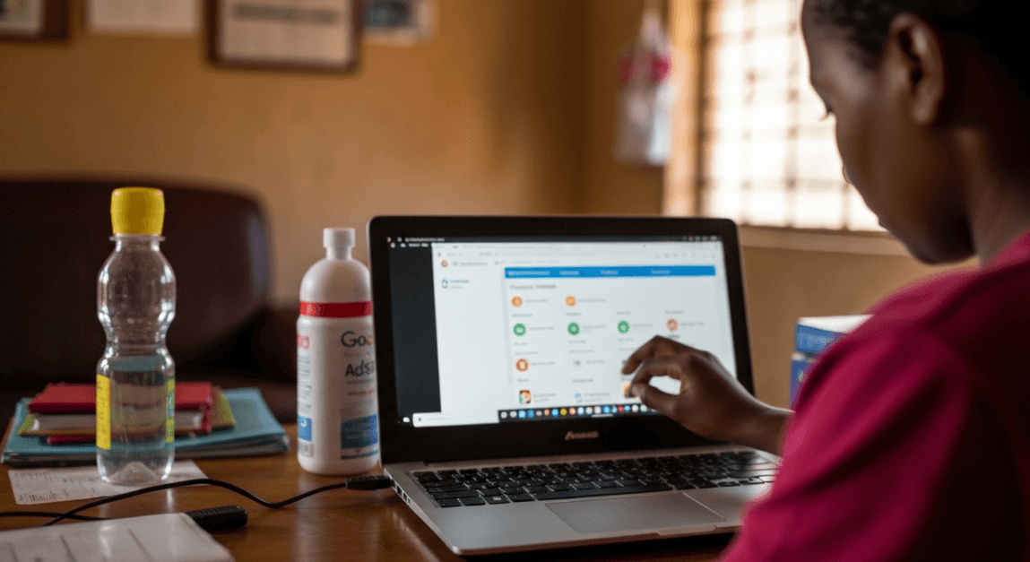 Person configuring Google AdSense on laptop in Botswana home office for strategic ad placement.