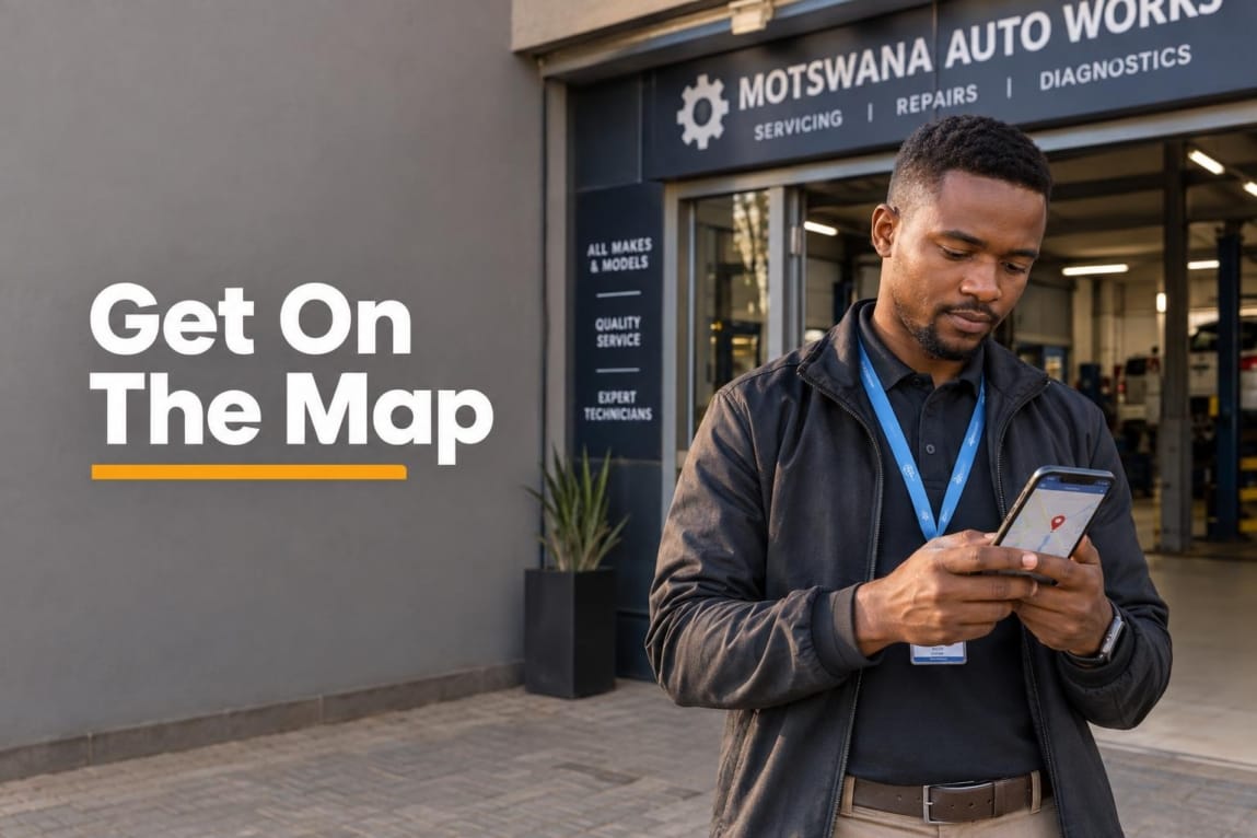 A Botswana business owner standing outside a commercial building holding a smartphone showing a map location marker.
