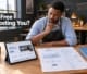 A Botswana small business owner comparing a website builder template on a tablet against custom website layout sketches on a studio workbench.