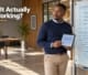 A Botswana business owner reviewing a website performance evaluation board and tablet in a modern office.