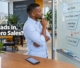 A marketing strategist analyzing a sales funnel diagram on a glass board showing a drop-off between lead acquisition and closed deals.