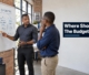 A Botswana business owner planning digital marketing budget allocations on an office whiteboard.