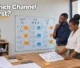 Two business owners evaluating digital marketing pathways on a whiteboard in an office workshop