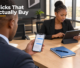 Botswana business manager managing incoming customer conversations on a smartphone beside an ad planning tablet.